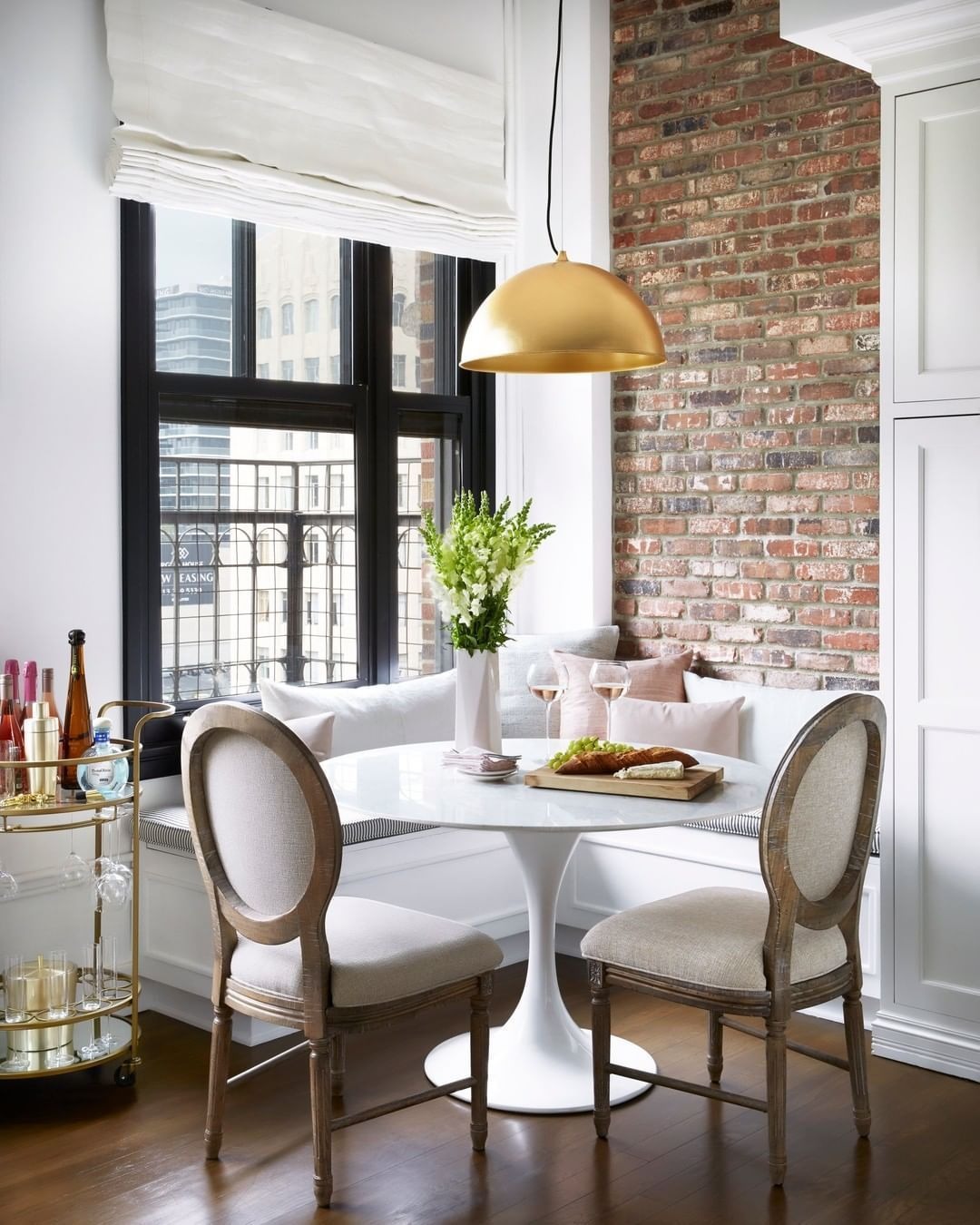 An Elegant Breakfast Nook with Raw Brick Wall